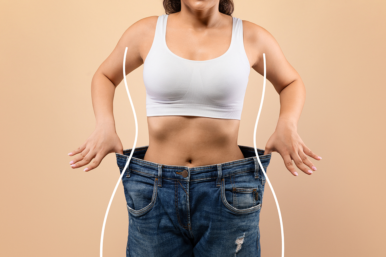 Woman in loose jeans representing liposuction body contouring and a slimmer silhouette in Boston.