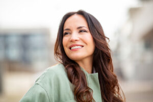 Smiling woman representing injectables for softer facial lines, restored volume, and a youthful glow.
