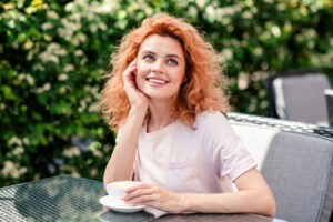 Smiling woman outdoors representing Juvederm Voluma XC for cheek volume and youthful facial rejuvenation.