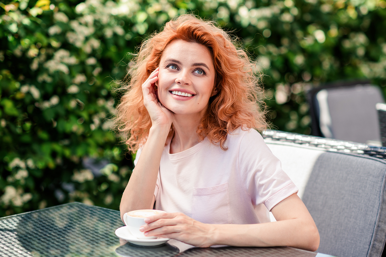 Smiling woman outdoors representing Juvederm Voluma XC for cheek volume and youthful facial rejuvenation.
