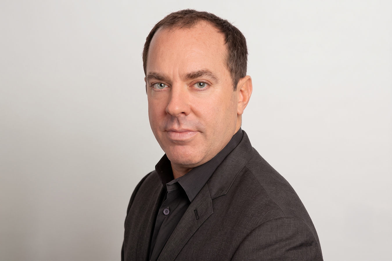 Portrait of a plastic surgeon, representing board certification and trusted surgical care.