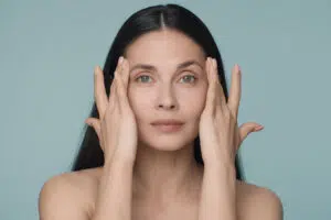 Woman touching temples for Botox forehead line and wrinkle treatment information