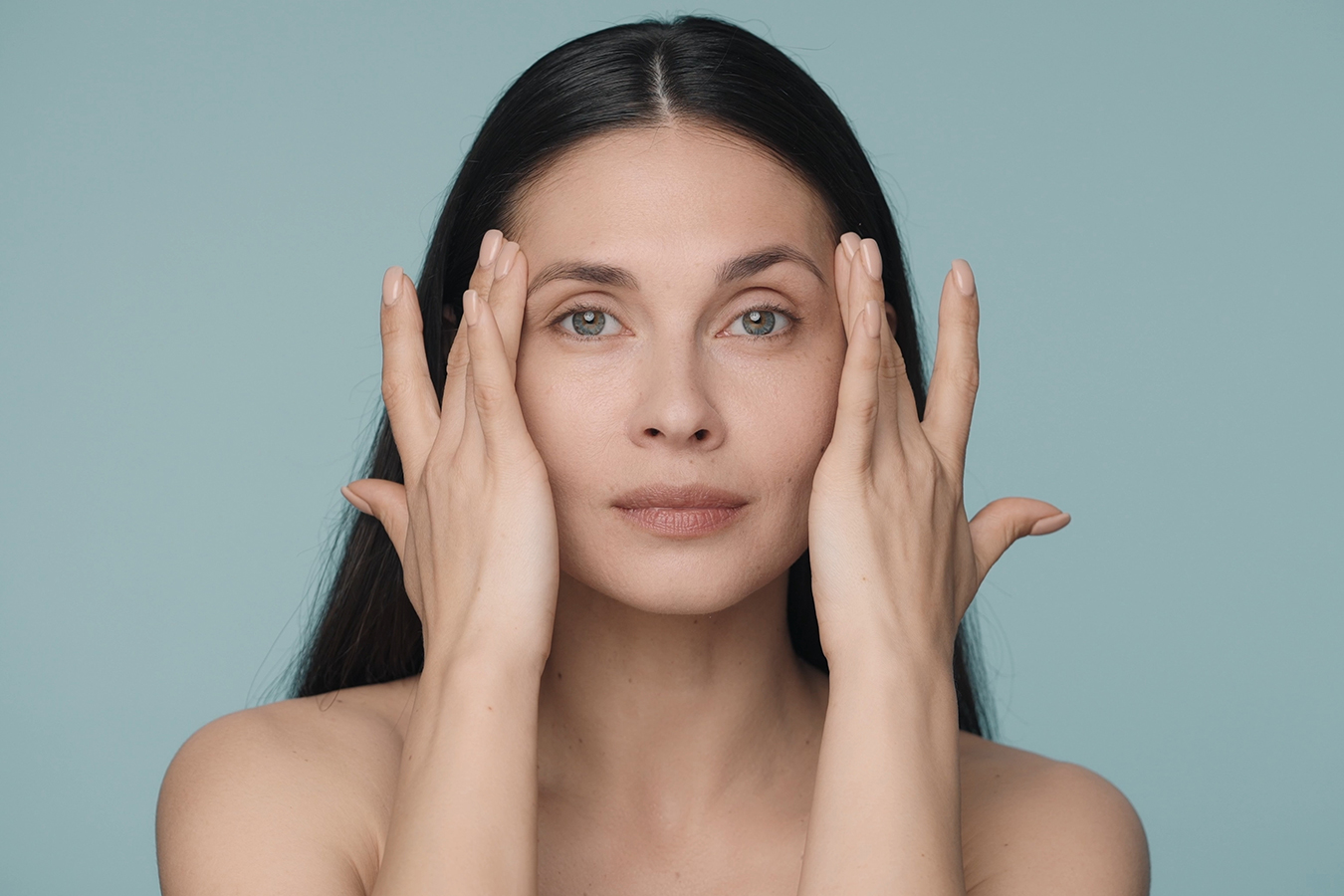Woman touching temples for Botox forehead line and wrinkle treatment information
