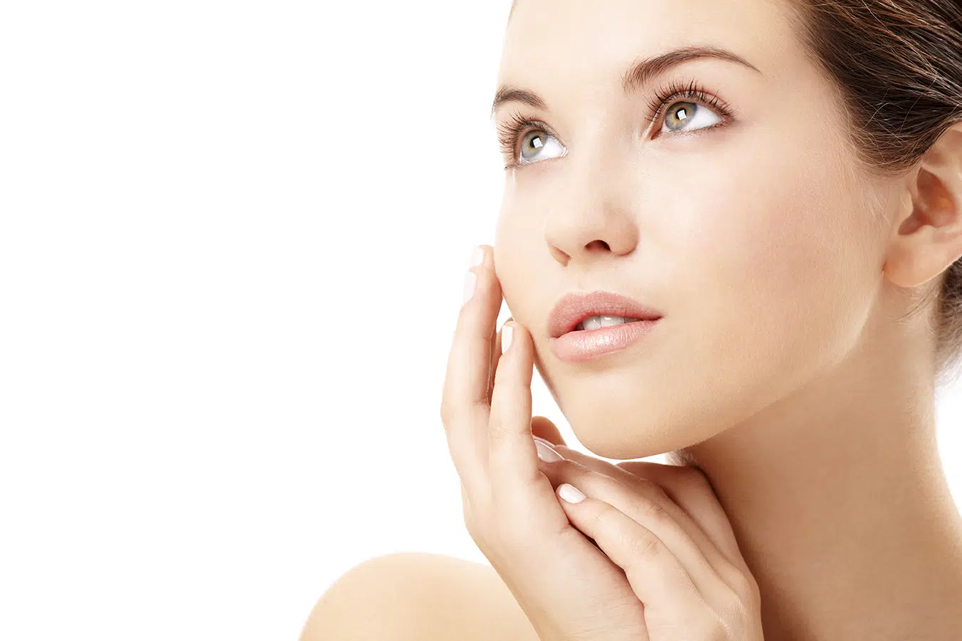 Woman touching her face, representing non-surgical facelift treatments for wrinkles, sagging, and lost volume.