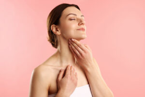 Woman touching chin for non-surgical double chin reduction and chin fat treatment information.