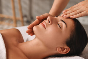 Woman receiving a relaxing facial treatment representing non-surgical skin rejuvenation options.