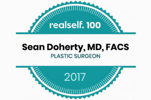 RealSelf 100 badge recognizing Dr. Sean Doherty as a leading plastic surgeon in 2017.