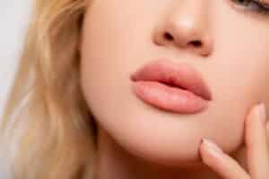 Close-up of naturally full lips suggesting careful enhancement without overdoing.