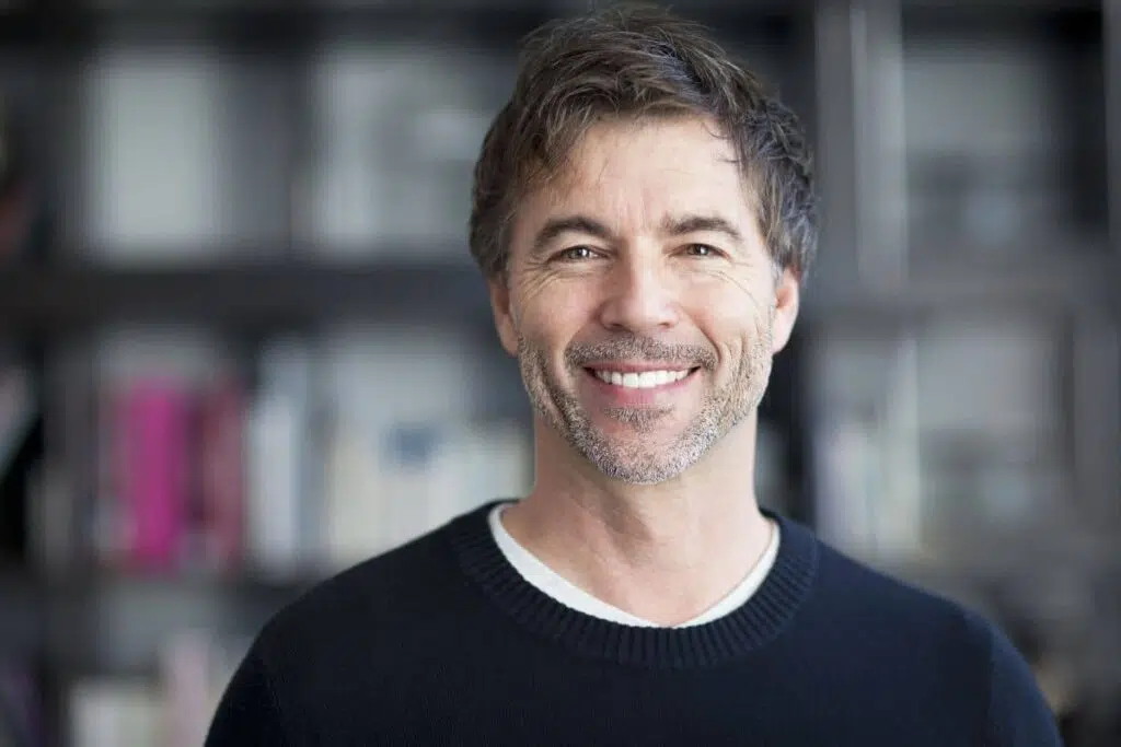 Confident middle-aged man smiling, representing rise in male cosmetic surgery and aesthetic self-care.