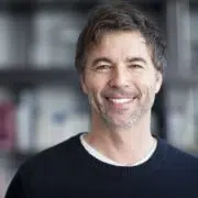 Confident middle-aged man smiling, representing rise in male cosmetic surgery and aesthetic self-care.
